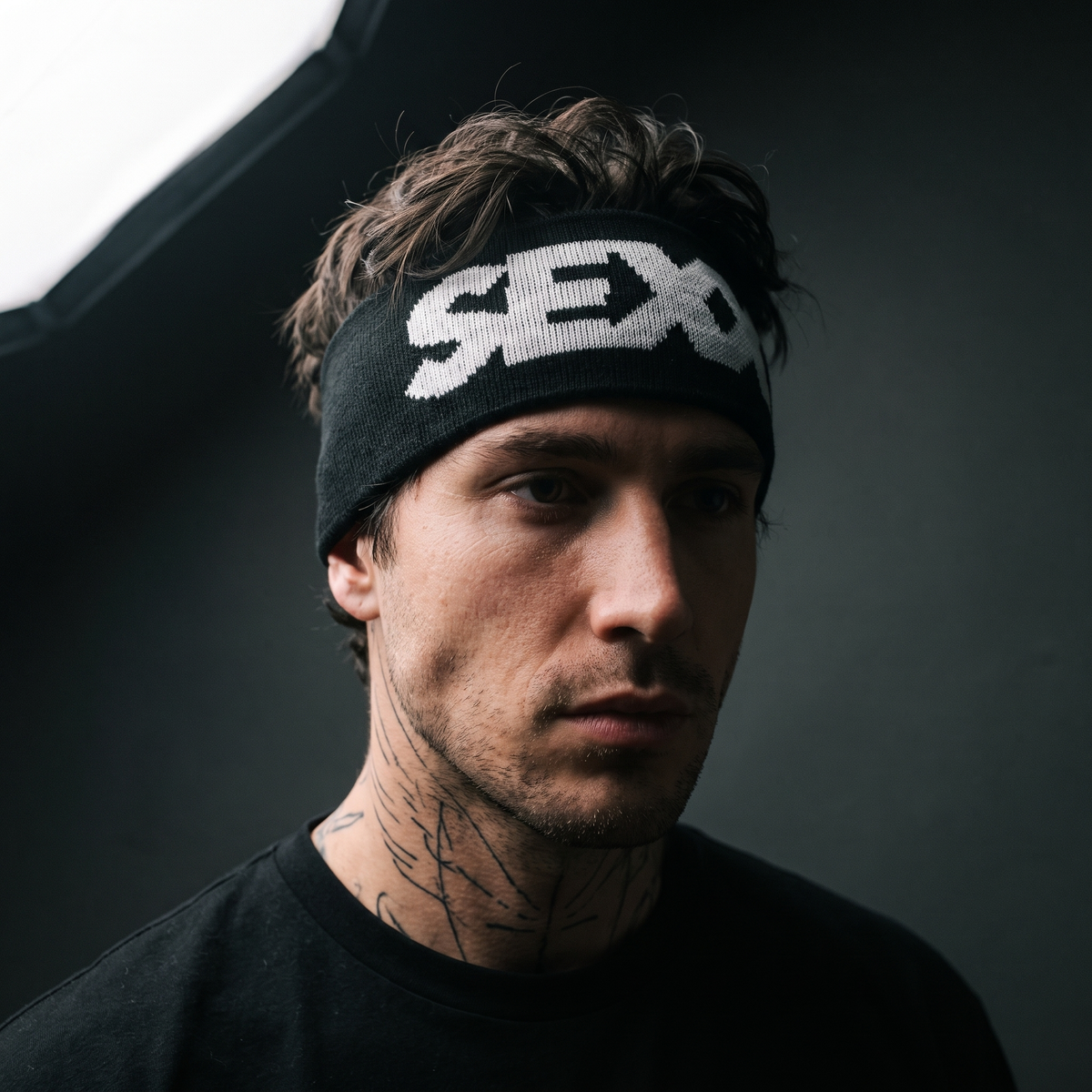 Sex Headband (black) worn on model — tattooed male